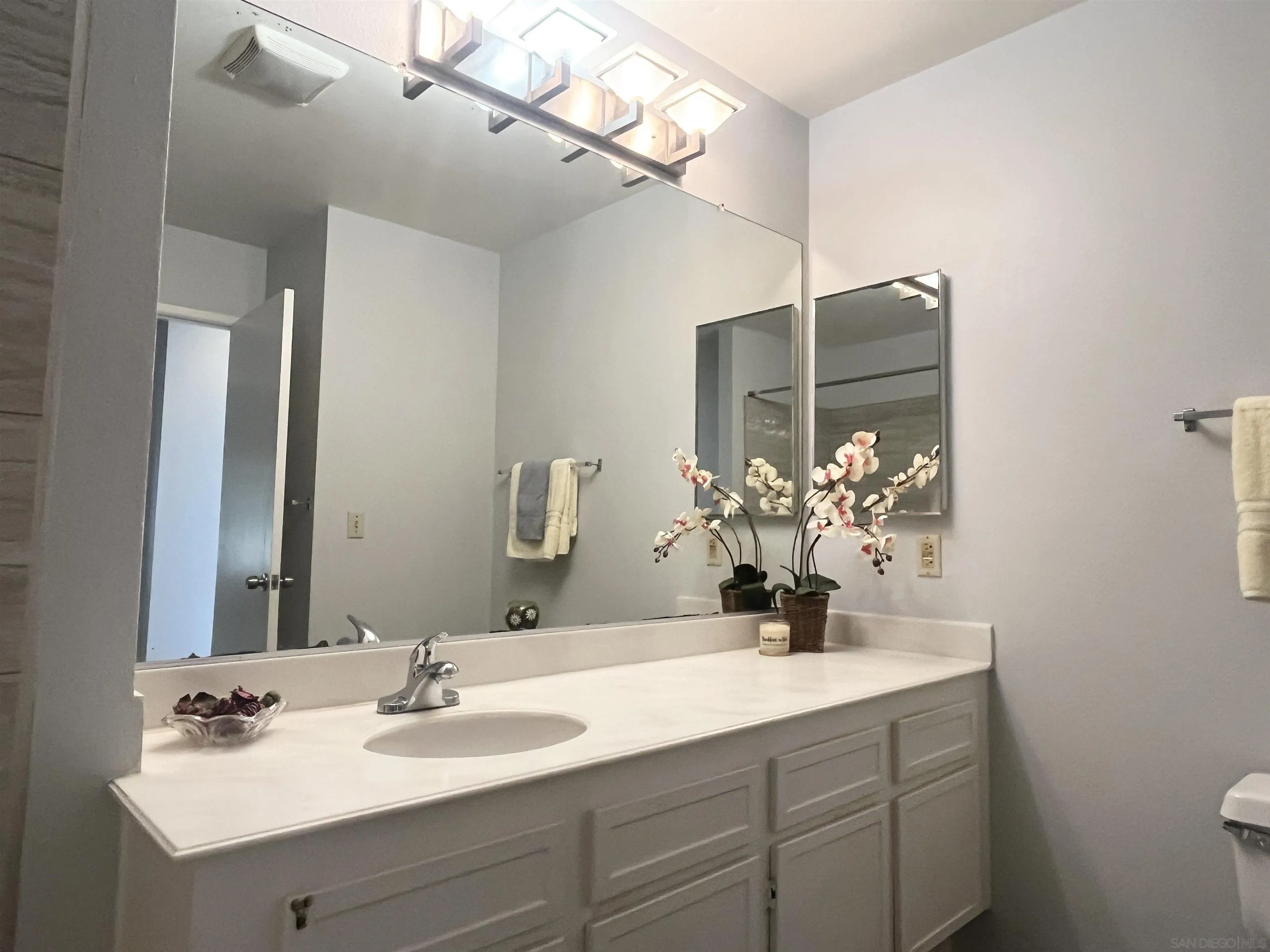 8365 Westmore Road, Unit 20 San Diego, CA 92126 - Photo 20 of 29 a bathroom with a sink double vanity and a mirror