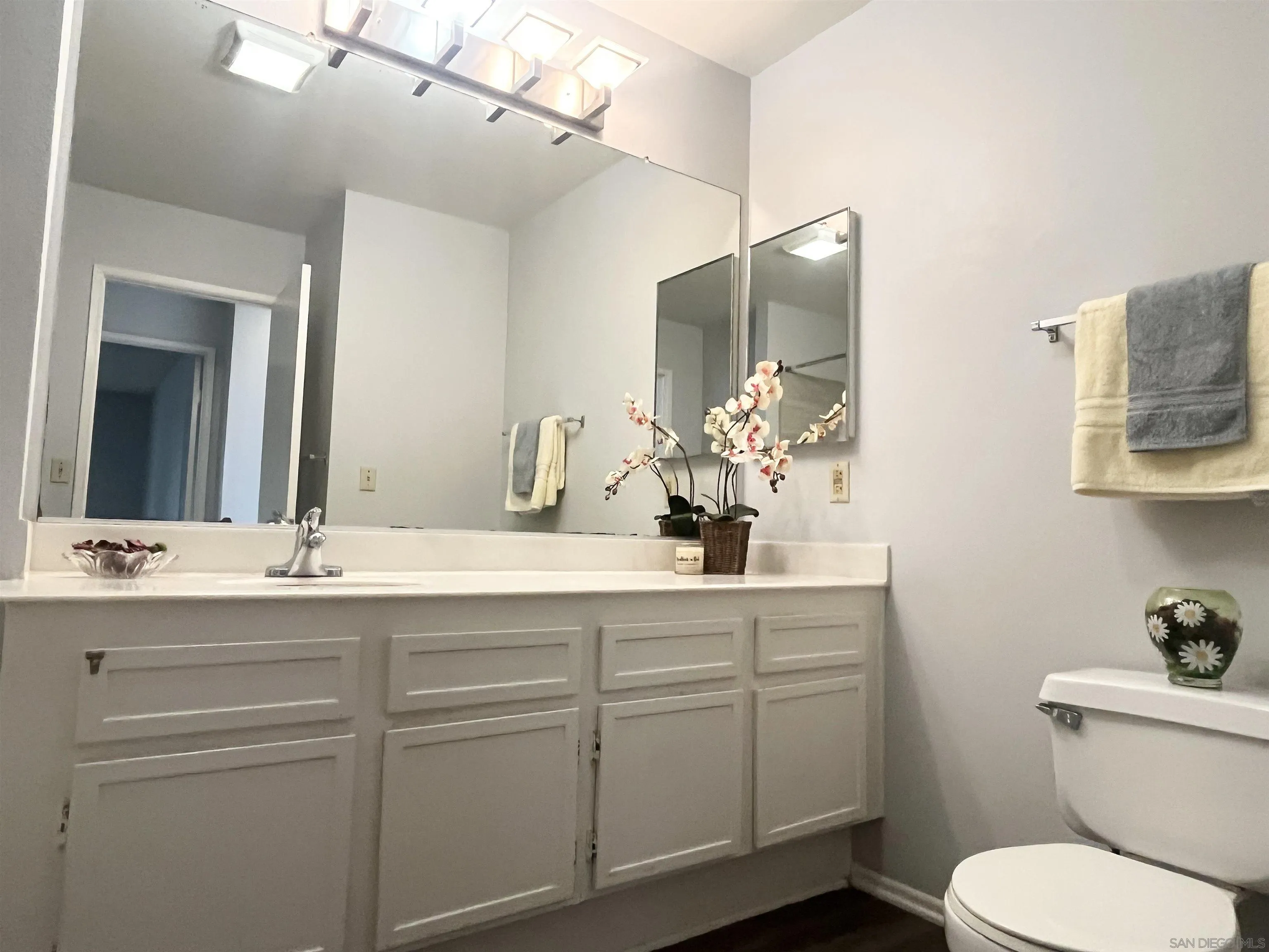 8365 Westmore Road, Unit 20 San Diego, CA 92126 - Photo 21 of 29 a bathroom with a toilet sink and mirror