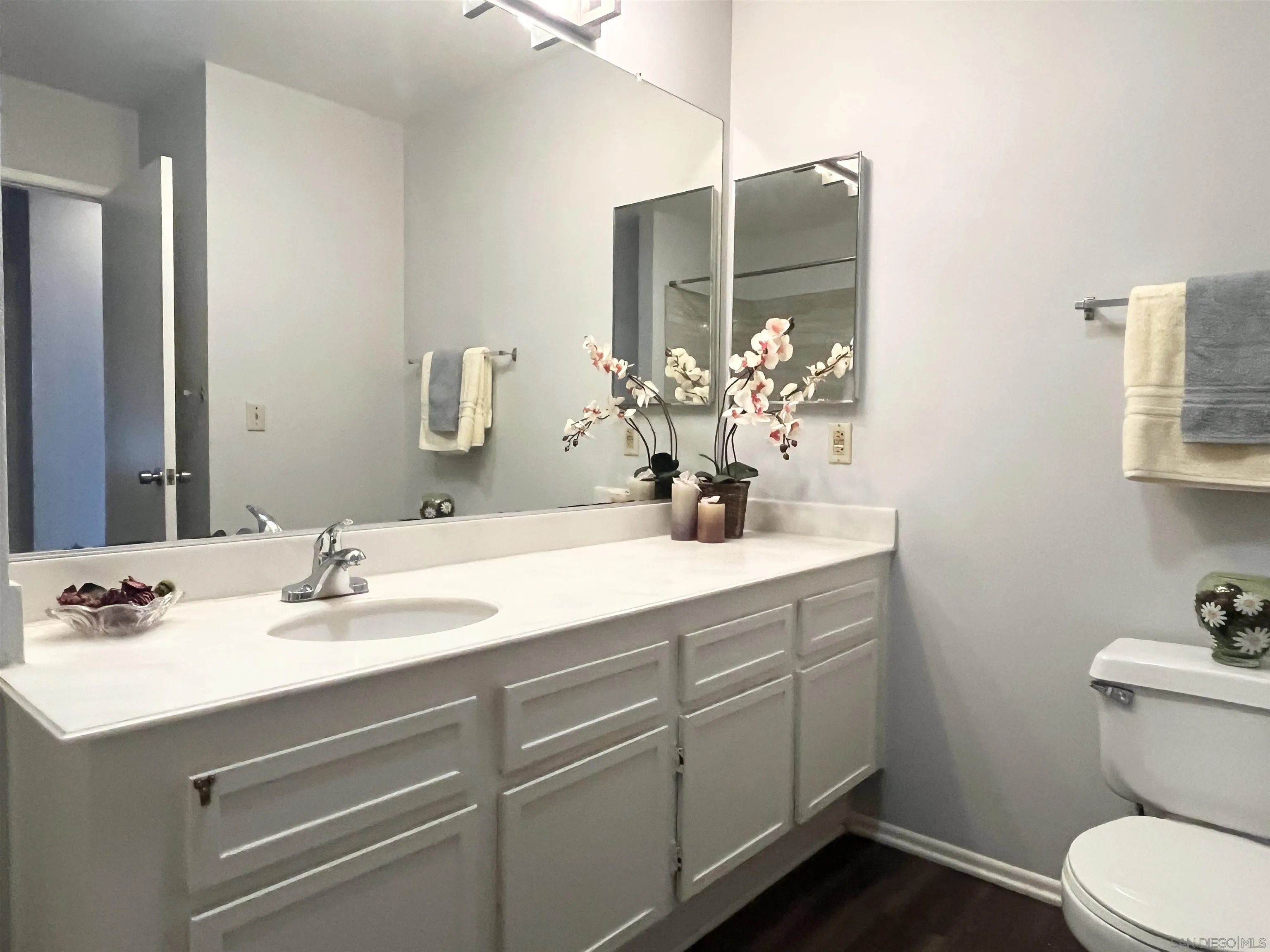 8365 Westmore Road, Unit 20 San Diego, CA 92126 - Photo 22 of 29 a bathroom with a sink toilet and mirror