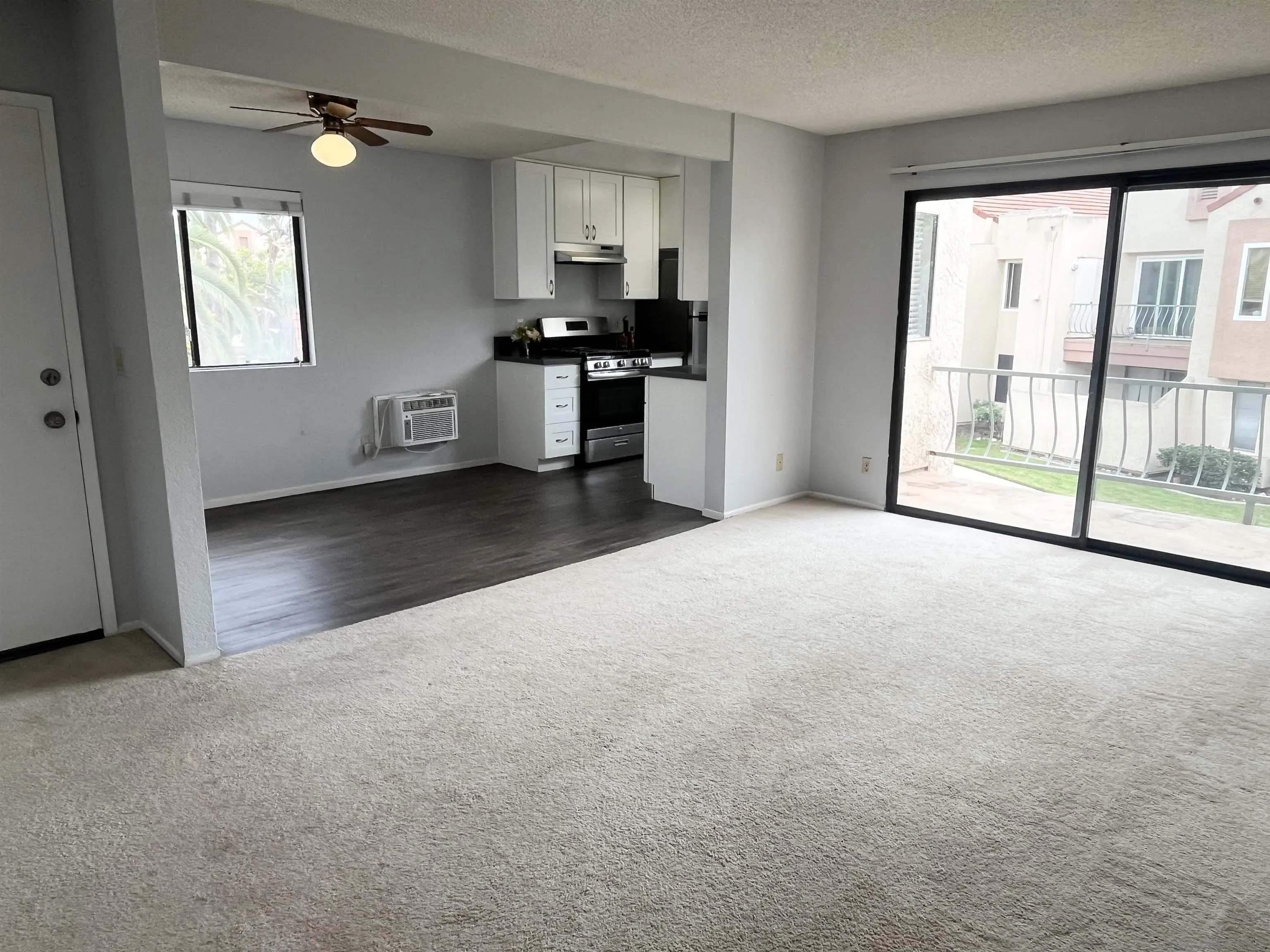 8365 Westmore Road, Unit 20 San Diego, CA 92126 - Photo 4 of 29 an empty room with windows and cabinet