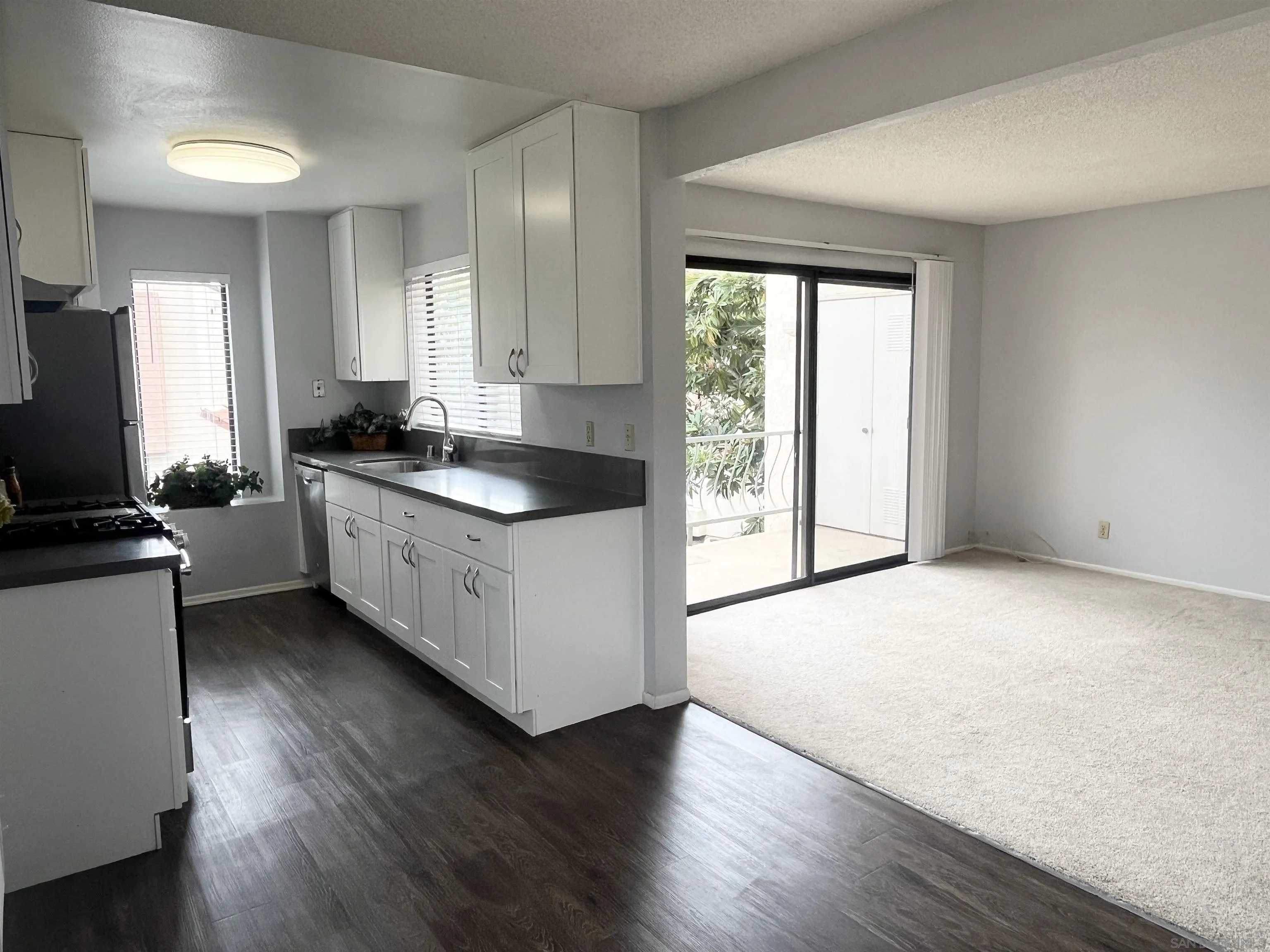 8365 Westmore Road, Unit 20 San Diego, CA 92126 - Photo 7 of 29 a kitchen with granite countertop a sink a counter top space and cabinets