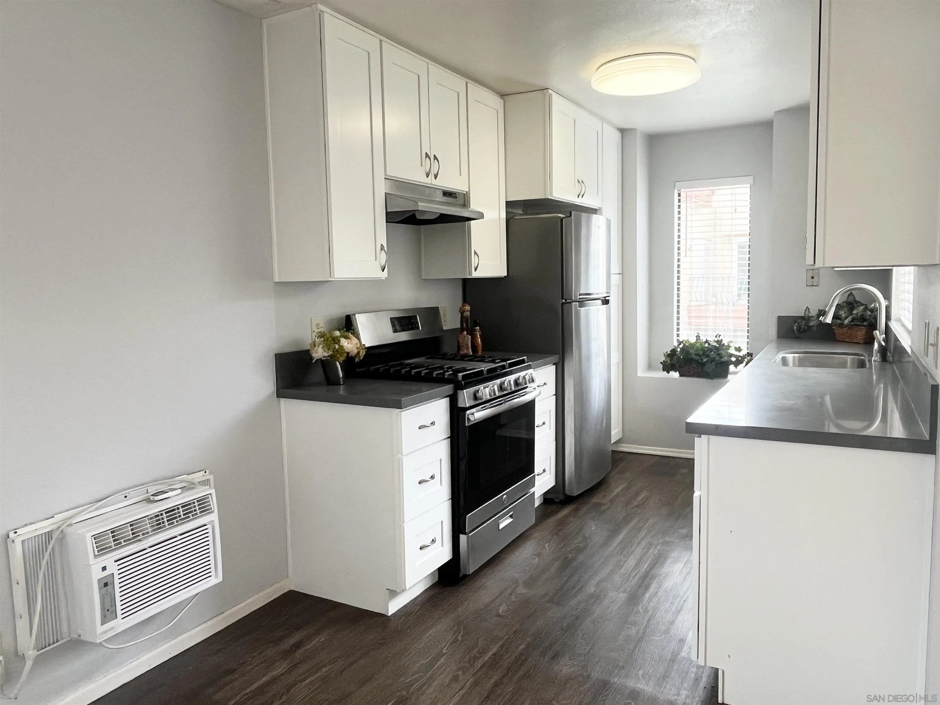 8365 Westmore Road, Unit 20 San Diego, CA 92126 - Photo 8 of 29 a kitchen with a sink white cabinets and stainless steel appliances