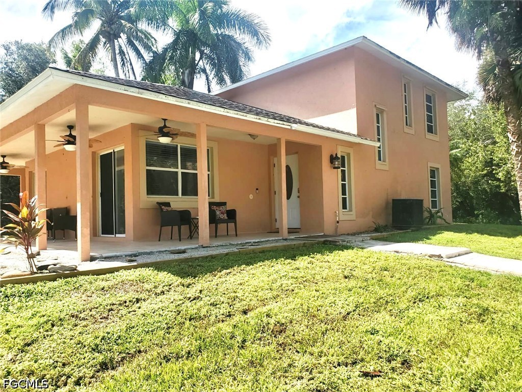 740 19th Street Southwest Naples, FL 34117 - Photo 3 of 35 front view of a house with a yard