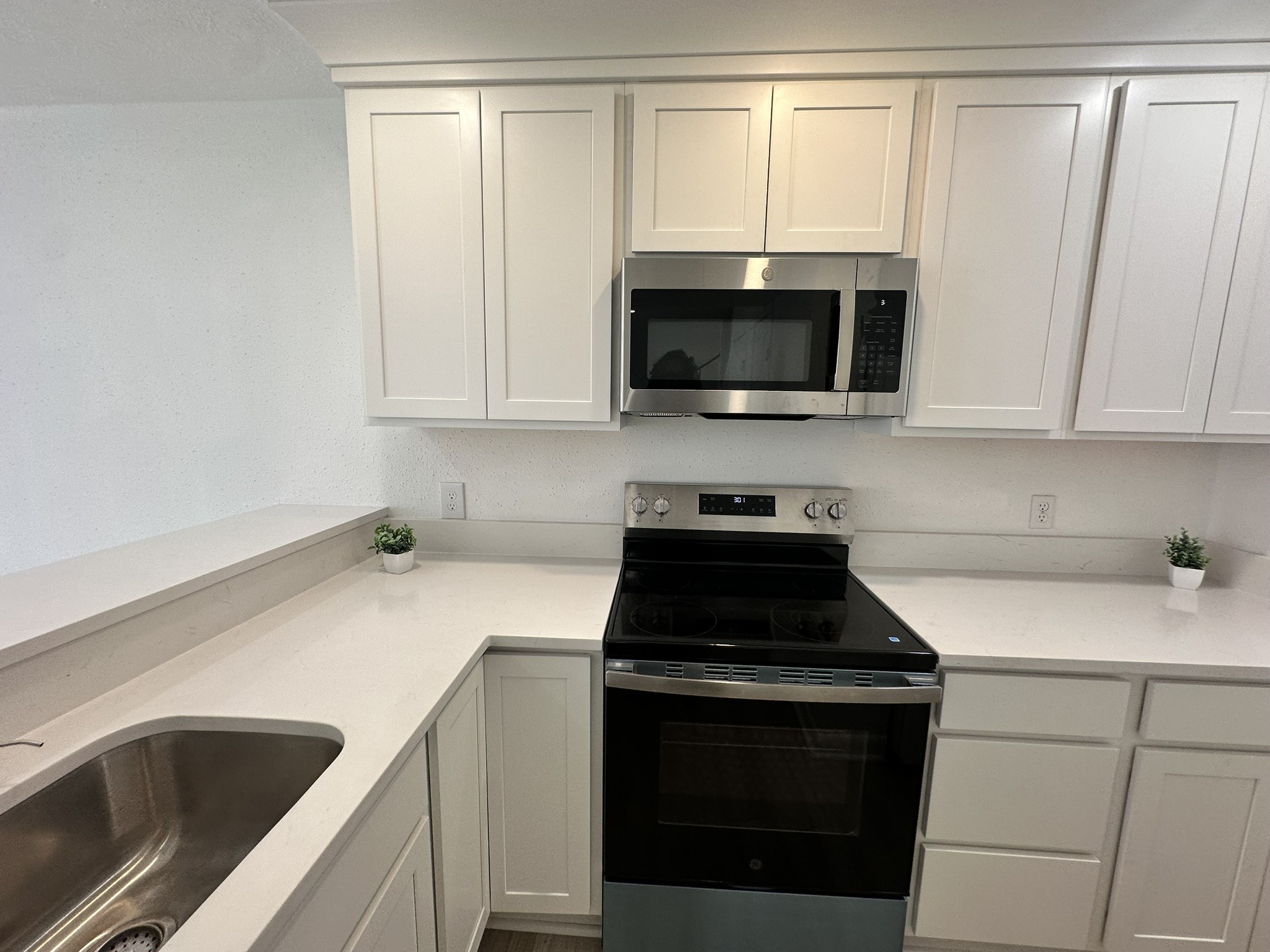 2800 Jeanetta Street, Unit 203 Houston, TX 77063 - Photo 12 of 34 a kitchen with a sink and a stove top oven