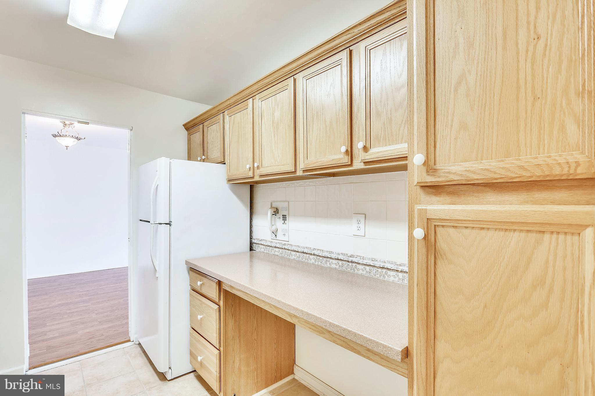 9701 Fields Road, Unit 1604 Gaithersburg, MD 20878 - Photo 3 of 30 a kitchen with stainless steel appliances a refrigerator and cabinets