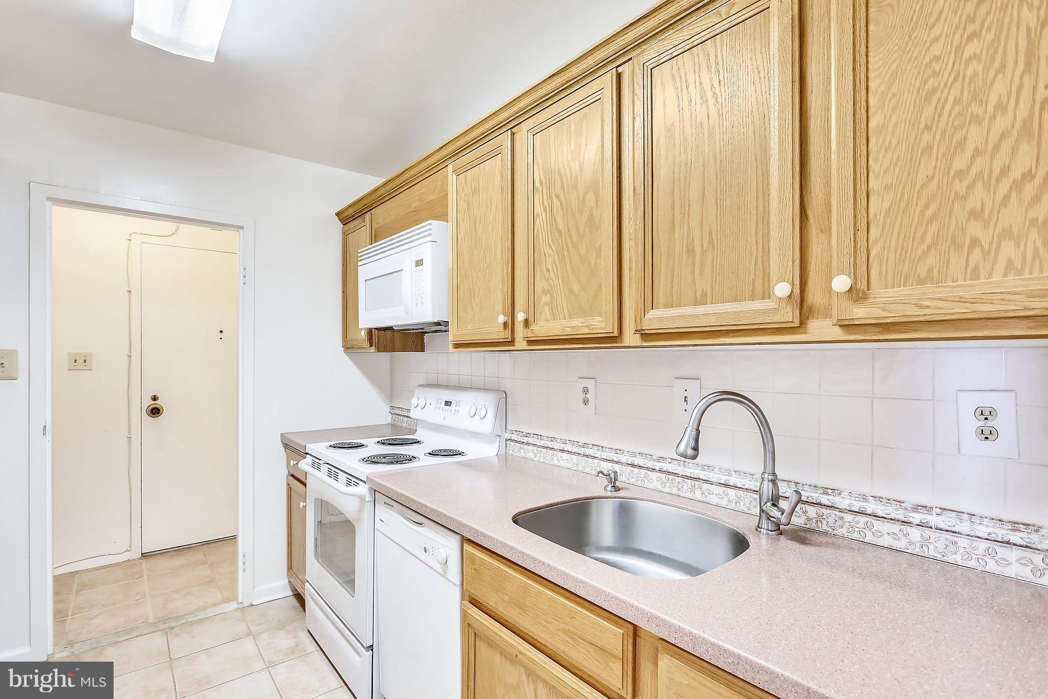 9701 Fields Road, Unit 1604 Gaithersburg, MD 20878 - Photo 4 of 30 a kitchen with stainless steel appliances a sink and a cabinets