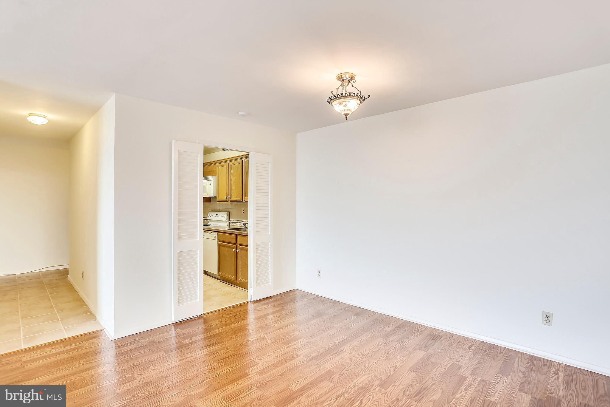 9701 Fields Road, Unit 1604 Gaithersburg, MD 20878 - Photo 6 of 30 a view of an empty room with wooden floor