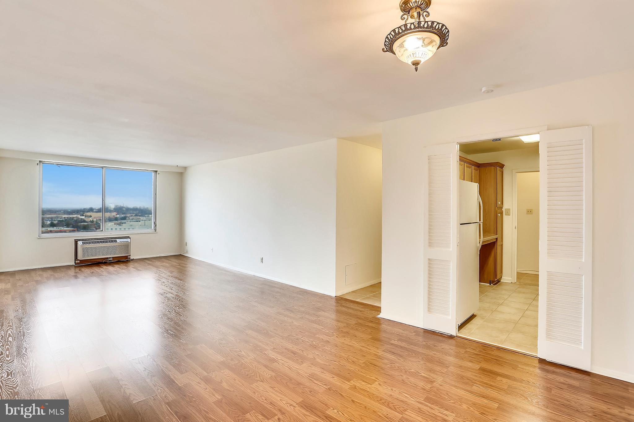 9701 Fields Road, Unit 1604 Gaithersburg, MD 20878 - Photo 7 of 30 a view of a room with wooden floor and a bathroom