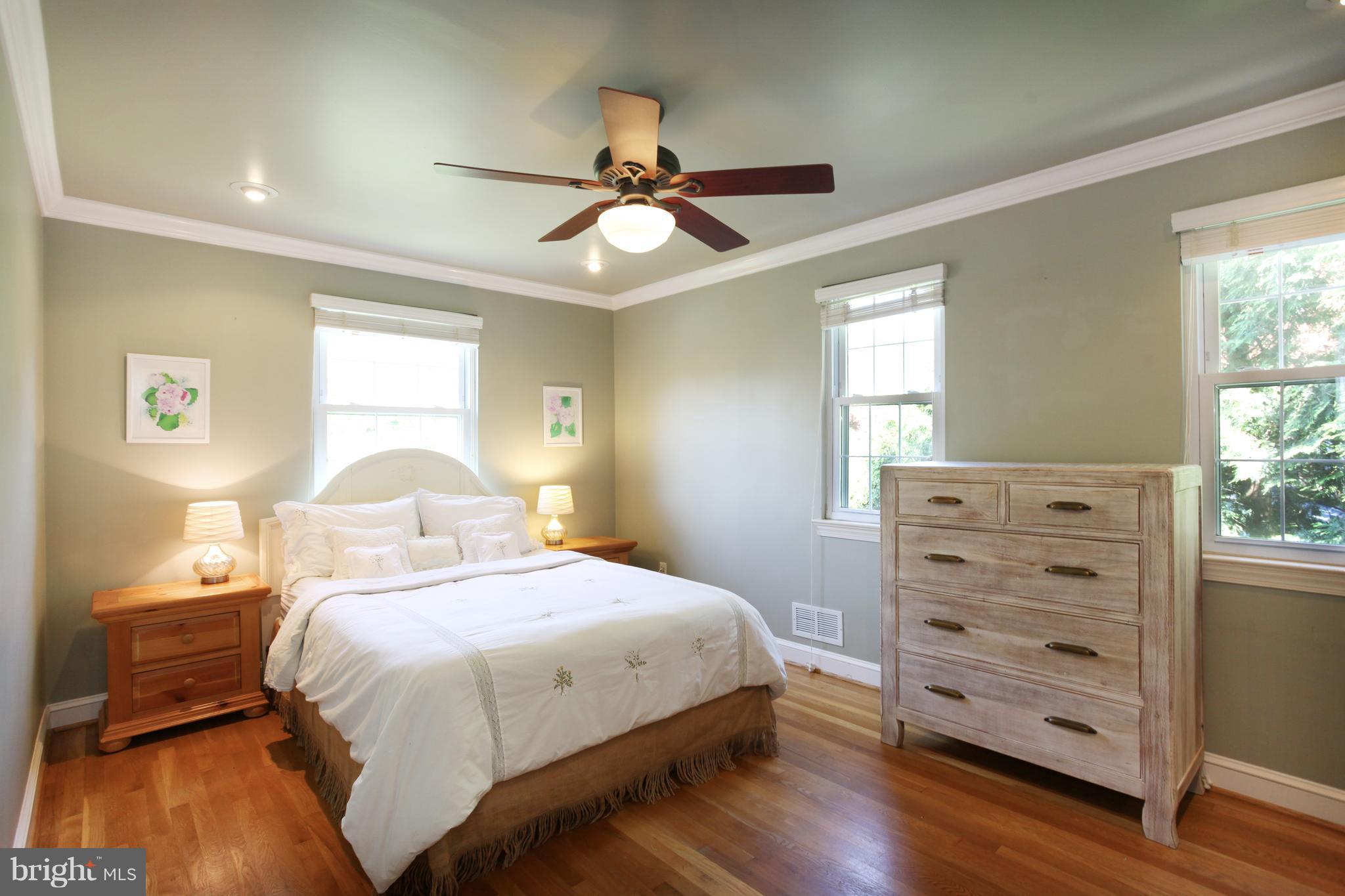 1022 Stirling Road Silver Spring, MD 20901 - Photo 14 of 30 a bedroom with a bed a dresser and a window