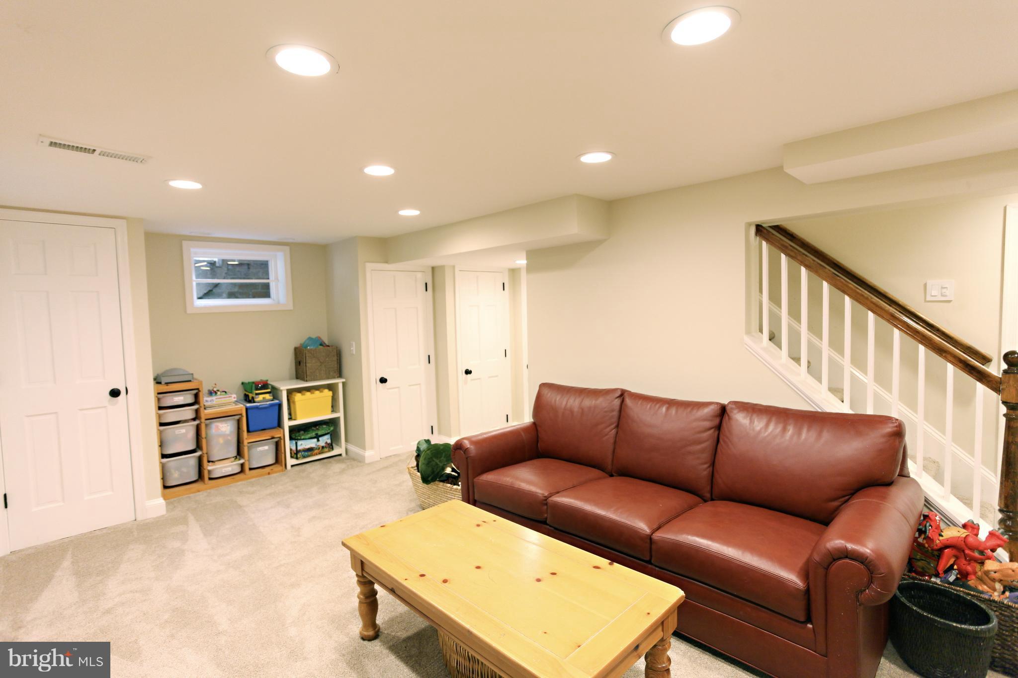 1022 Stirling Road Silver Spring, MD 20901 - Photo 22 of 30 a living room with furniture and a dining table with projector
