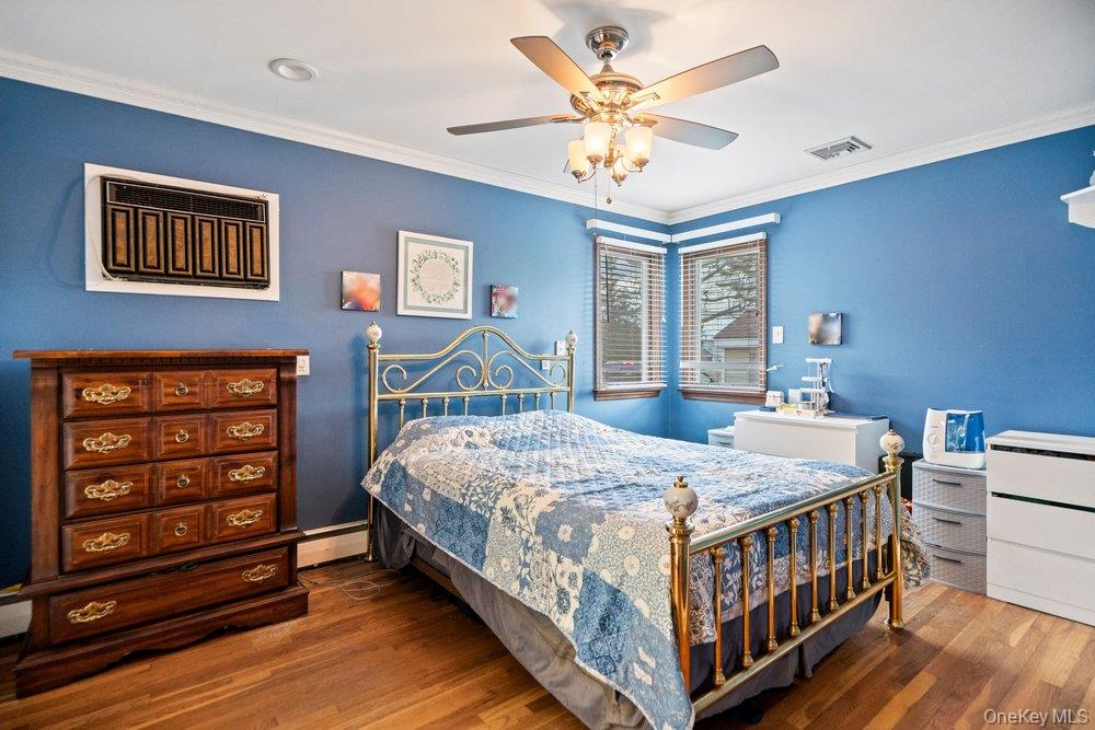 101 Sexton Road West Babylon, NY 11704 - Photo 19 of 33 a bedroom with a bed and a chandelier