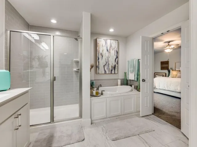 a spacious bathroom with a double vanity sink and a mirror