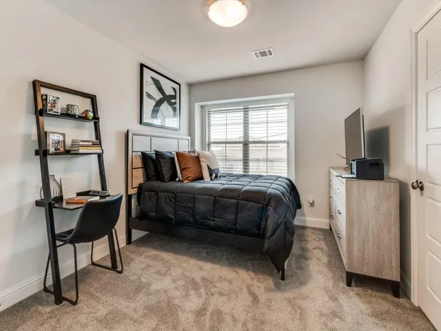 a bedroom with a bed and a table