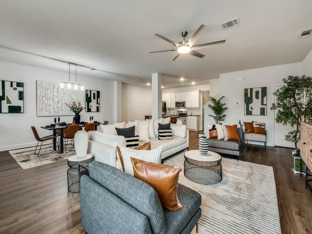a living room with furniture and view of kitchen