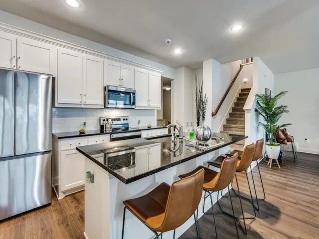 a kitchen with counter space dining table and chairs
