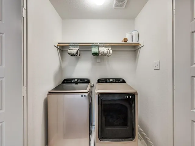 a kitchen with stainless steel appliances granite countertop a table chairs sink and cabinets