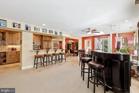a living room with furniture a flat screen tv and a large window