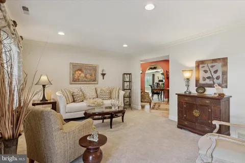 a living room with furniture a rug and a window