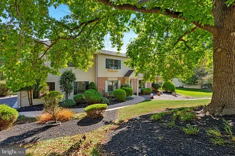 a view of a house with swimming pool and yard