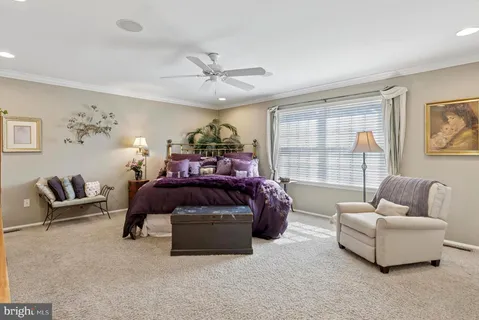 a spacious bedroom with a bed and a flat screen tv