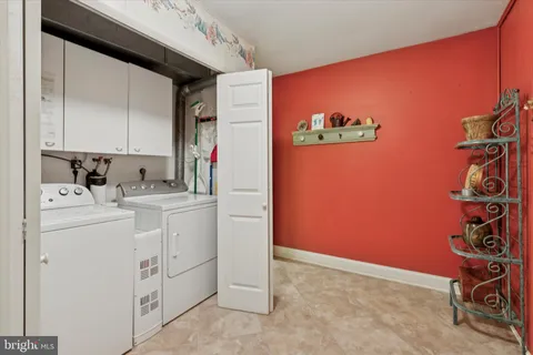 a view of a storage & utility room with dryer and washer