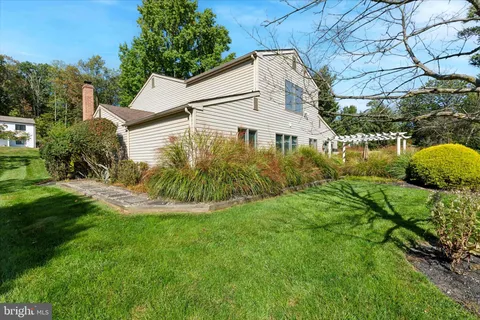 a aerial view of a house with a yard table and chairs