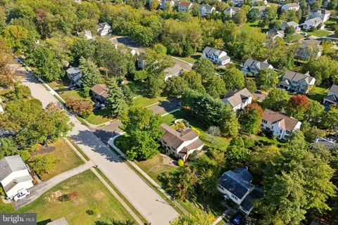 an aerial view of a house with a yard basket ball court and outdoor seating