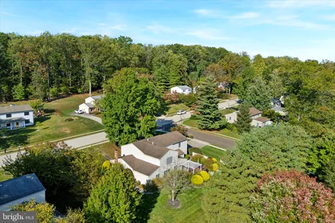 an aerial view of a house with a yard and swimming pool