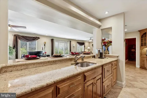 a view of center island kitchen island a sink a counter space and living room