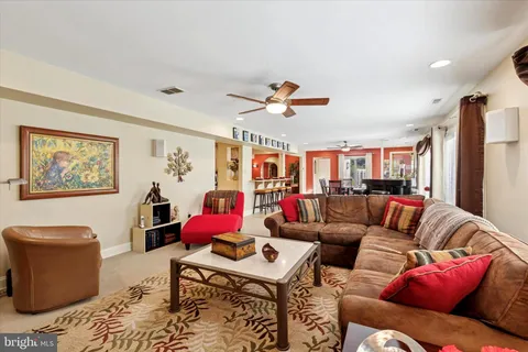 a living room with furniture a rug and a chandelier