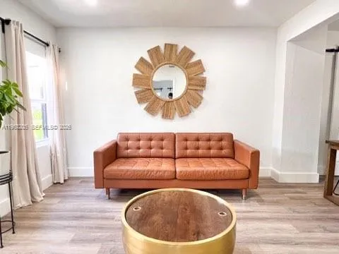 a living room with a couch and a chandelier