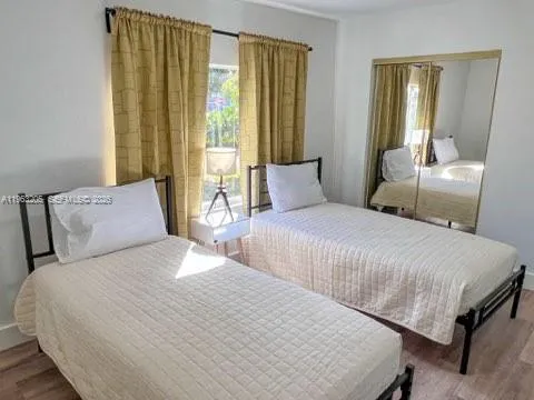 a bedroom with a bed and a large mirror