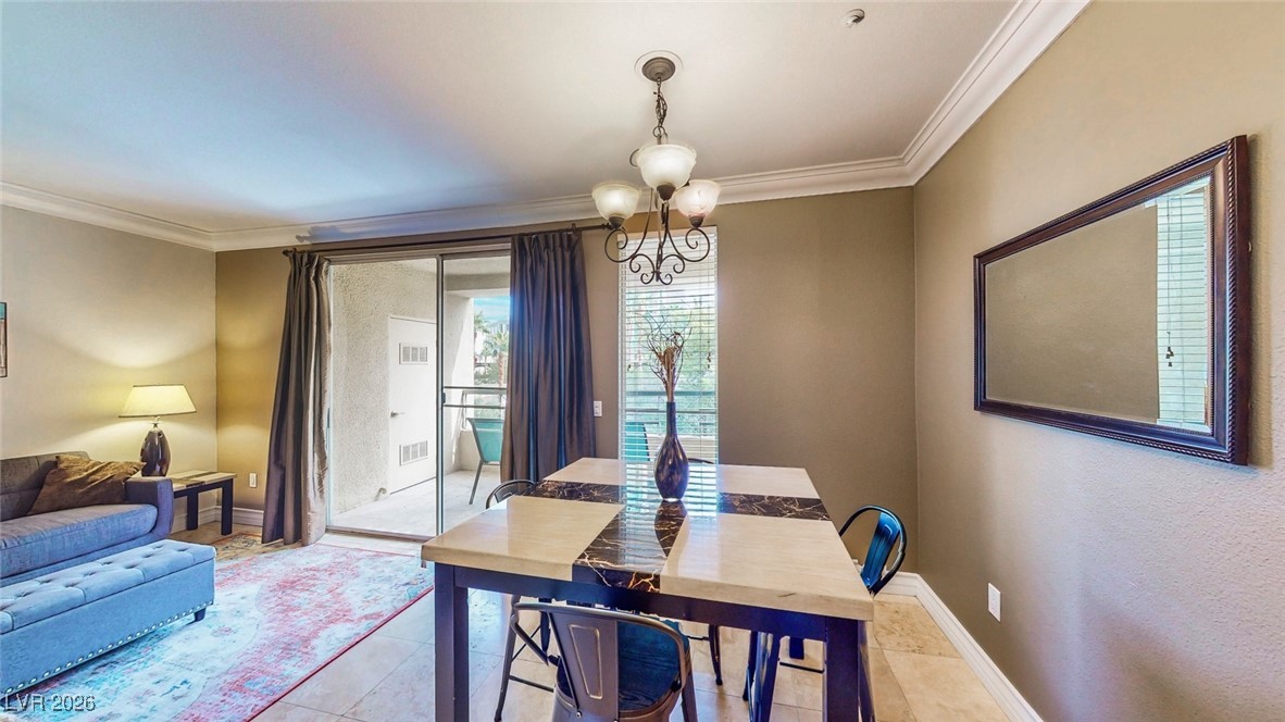 260 East Flamingo Road, Unit 229 Las Vegas, NV 89169 - Photo 29 of 31 Dining room featuring ornamental molding and hanging lights