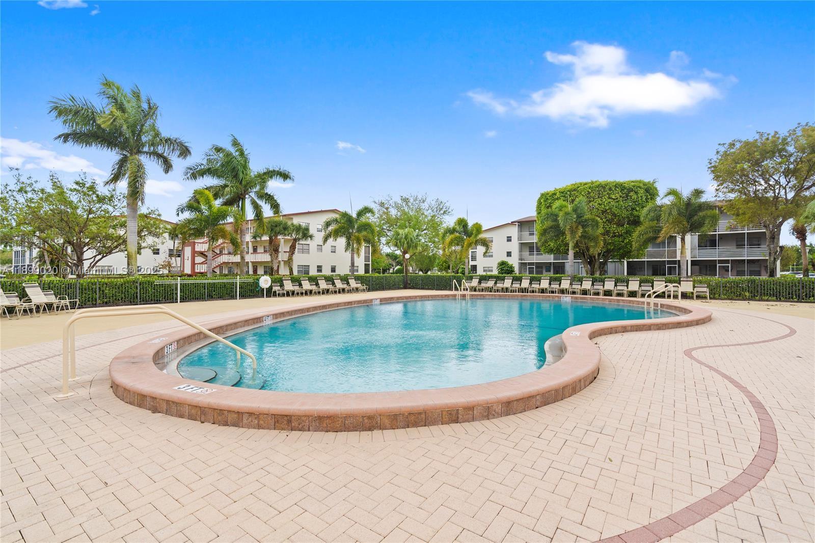 365 Brighton I, Unit 365 Boca Raton, FL 33434 - Photo 21 of 21 a view of a swimming pool with a garden