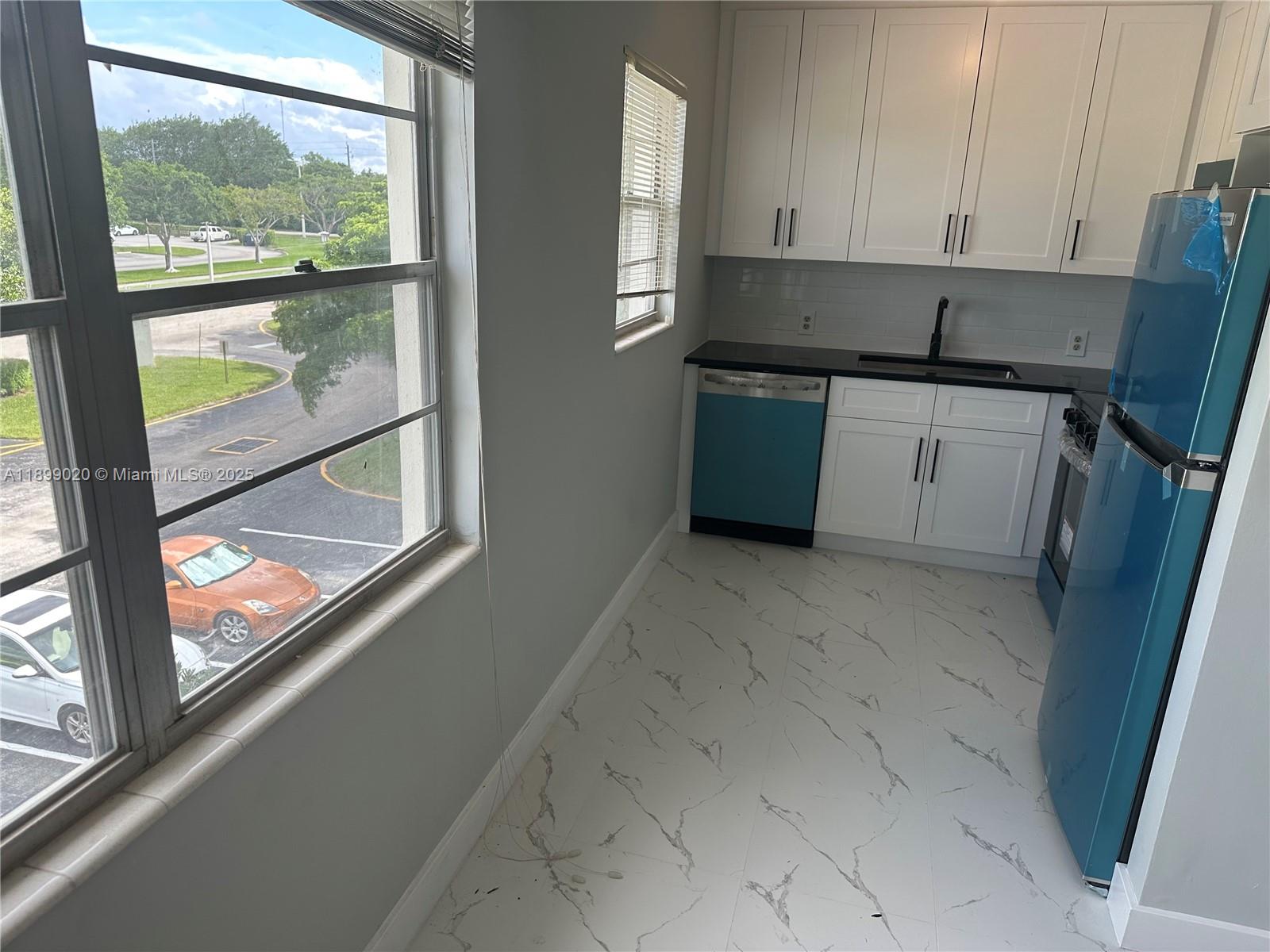 365 Brighton I, Unit 365 Boca Raton, FL 33434 - Photo 4 of 21 a kitchen with a sink a counter top space and a window