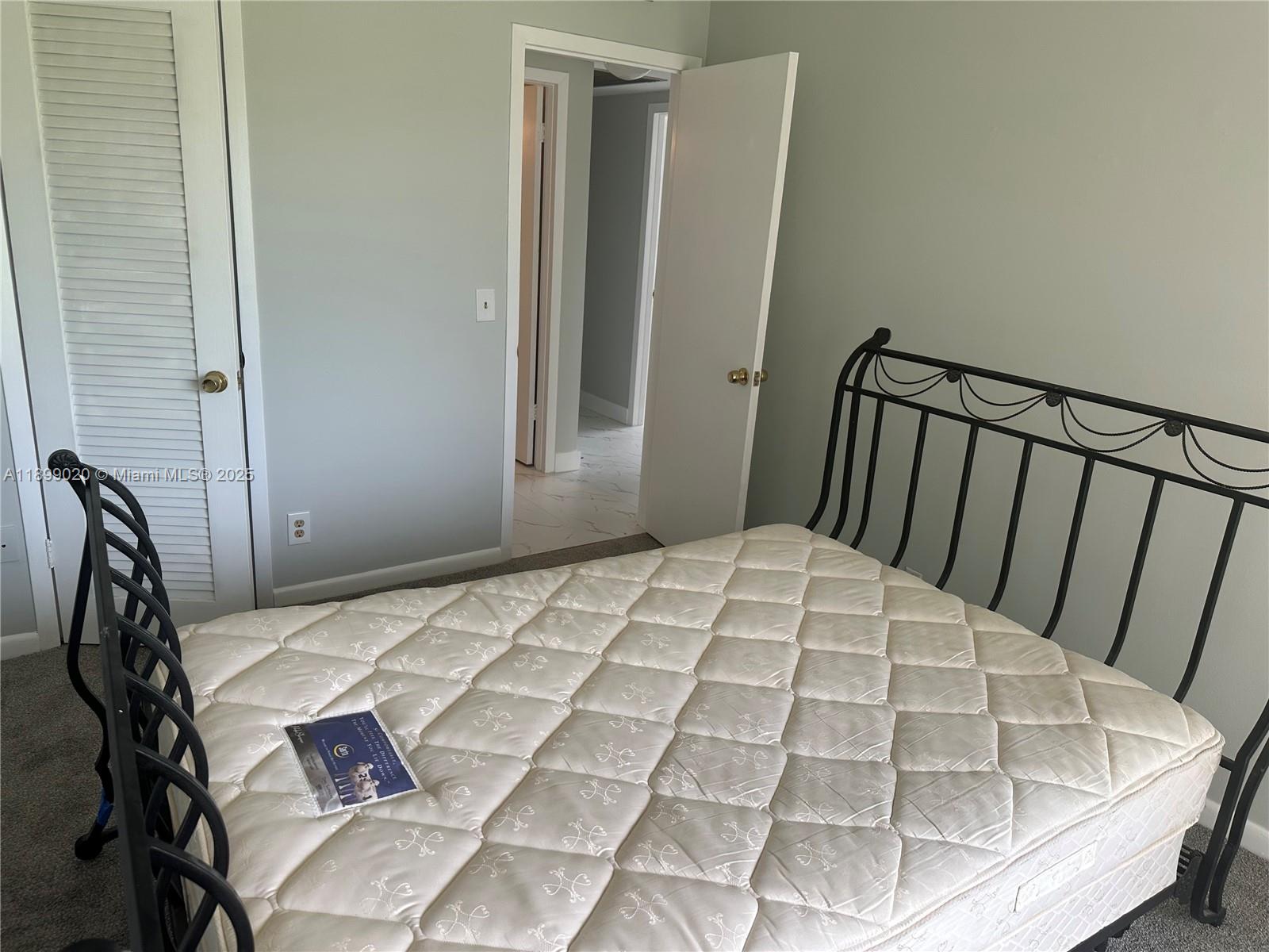 365 Brighton I, Unit 365 Boca Raton, FL 33434 - Photo 8 of 21 a view of a bedroom with a bed and wooden floor