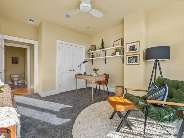 a living room with furniture a rug and a chandelier
