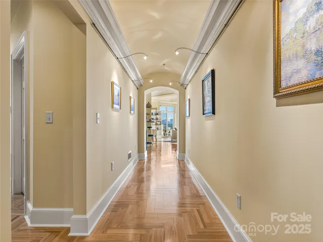 a view of a hallway with wooden floor and staircase