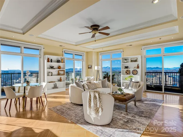 a living room with furniture a rug and a chandelier