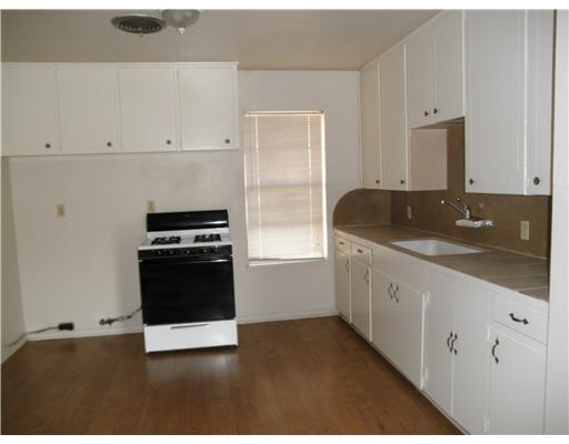 1414 Cook Odem, TX 78370 - Photo 3 of 5 a kitchen with granite countertop white cabinets and stainless steel appliances