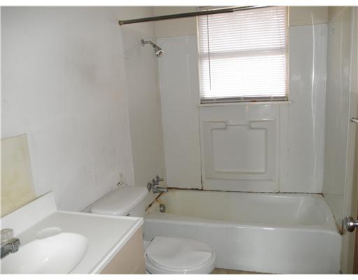 1414 Cook Odem, TX 78370 - Photo 5 of 5 a white bath tub sitting next to a window