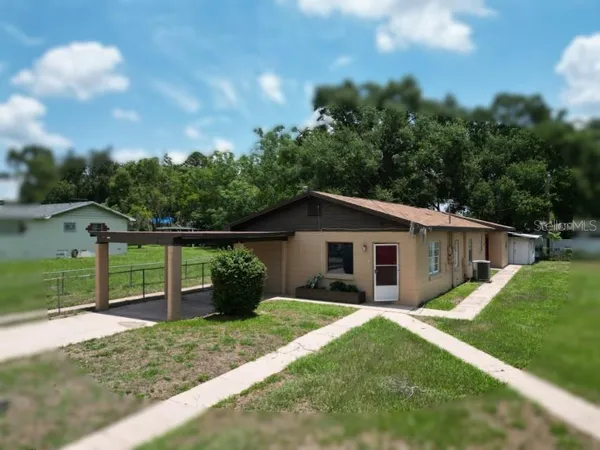 a view of a house with a yard and a garden
