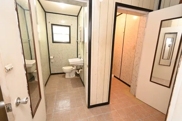 a view of a bathroom from a corridor