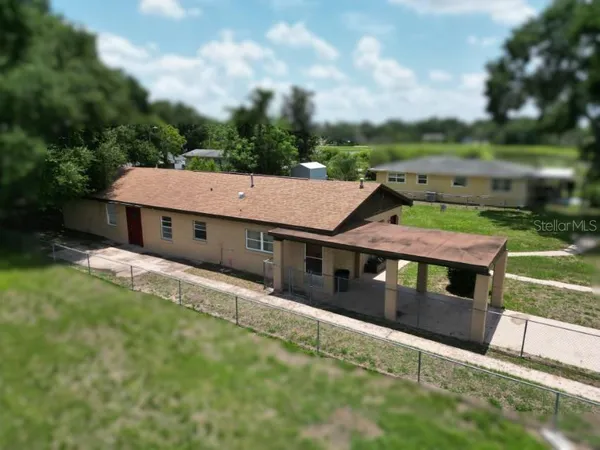 an aerial view of a house with a yard