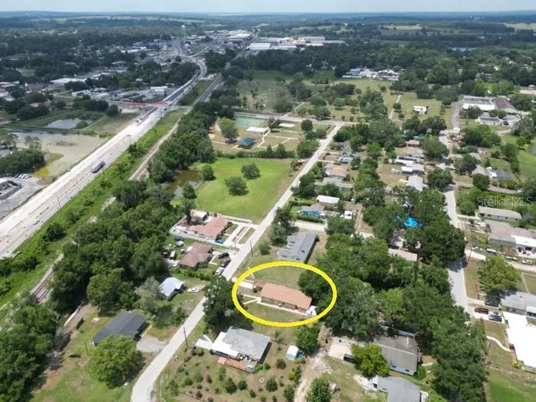 an aerial view of a residential houses with outdoor space and swimming pool