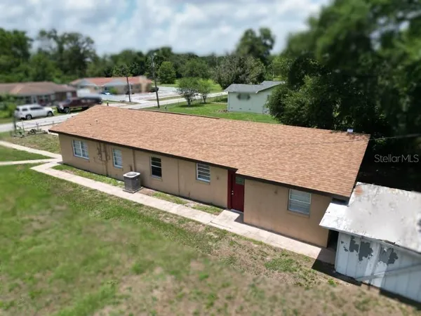 an aerial view of a house with a yard