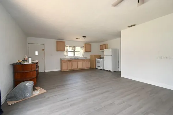 a view of a kitchen with a sink and a refrigerator