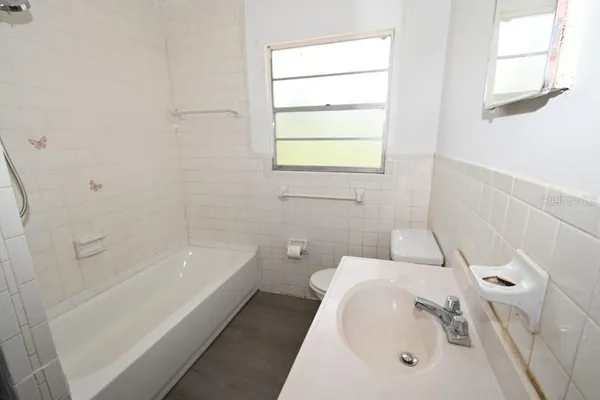 a bathroom with a sink a toilet and bathtub
