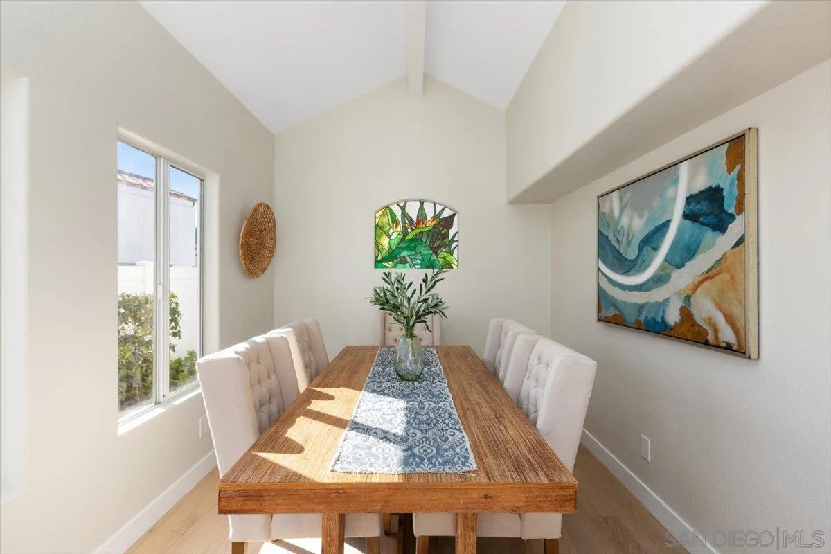4692 Adra Way Oceanside, CA 92056 - Photo 12 of 51 a view of a dining room with furniture a potted plant and wooden floor