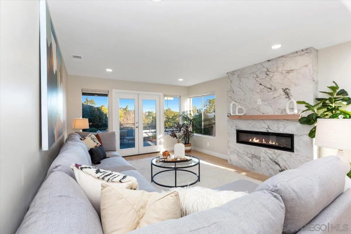4692 Adra Way Oceanside, CA 92056 - Photo 13 of 51 a living room with furniture a fireplace and a table